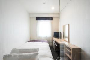Nagasaki Bus Terminal Hotel客房内的一张或多张床位