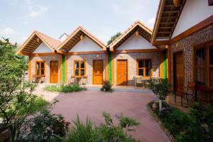 a house with orange doors and a patio at Tam Coc Cozy Homestay in Ninh Binh