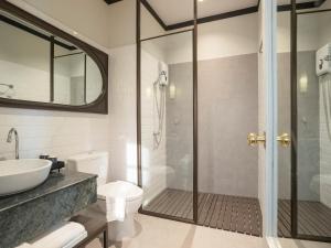 ein Badezimmer mit Dusche, Toilette und Waschbecken in der Unterkunft The Raweekanlaya Bangkok in Bangkok
