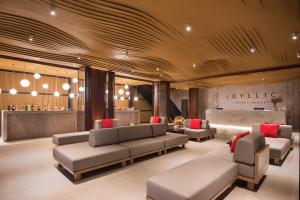 a lobby with couches and a bar in the background at Idyllic Concept Resort in Ko Lipe