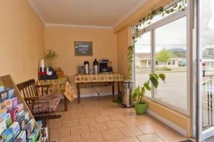 a room with a window and a table and chairs at Riviera Inn in Port Angeles