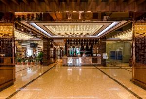 a lobby of a building with a bar in it at Grand Hill Hotel Ulaanbaatar in Ulaanbaatar