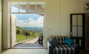 a living room with a door open to a view at Villa Verde Ella in Ella