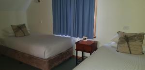 a room with two beds and a nightstand with a window at Richmond Barracks in Richmond +18 photos