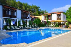 a large swimming pool in front of a hotel at Ford Hotel in Adrasan