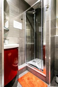 a shower with a glass door in a bathroom at Noella's Suite in Lille