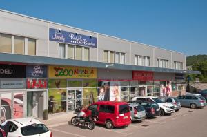 a parking lot with cars parked in front of a building at Sobe Rooms Nataly in Sežana