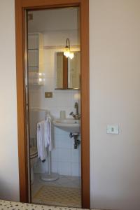 a bathroom with a sink and a mirror at Affittacamere Monica in Monterosso al Mare