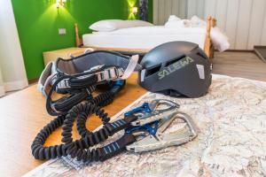 a helmet and a helmet on top of a table at Affittacamere Al Canyon PUB BIRRERIA in Fondo
