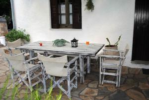 a wooden table and chairs on a patio at Villa Katerina in Platanias