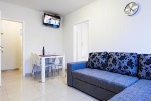 a living room with a couch and a table at Apartments Kalelarga in Zadar
