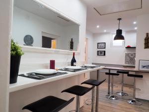 a kitchen with a counter and bar stools at Deluxe Zoya Centar in Pula