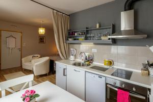 a kitchen with a sink and a counter top at Apartments Mardešić in Komiža