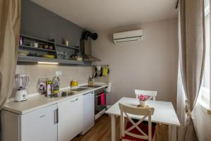 a small kitchen with a sink and a counter at Apartments Mardešić in Komiža