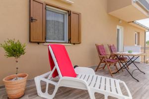 a pair of chairs and a table in a room at Apartments Mardešić in Komiža