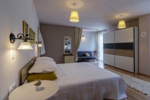 a bedroom with a large bed and a table at Apartments Mardešić in Komiža