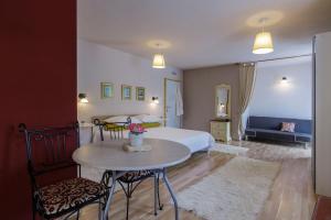 a bedroom with a bed and a table and chairs at Apartments Mardešić in Komiža