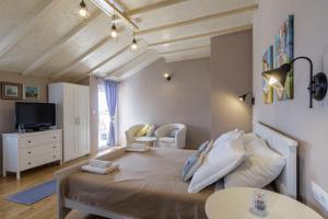 a bedroom with a large bed and a tv at Apartments Mardešić in Komiža