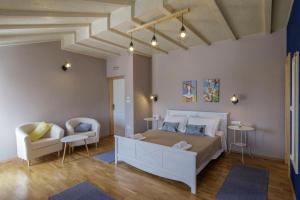 a bedroom with a bed and a couch and a chair at Apartments Mardešić in Komiža