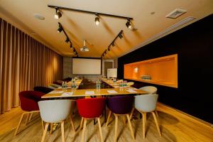 a conference room with a long table and chairs at Campanile Nanjing Jiangning in Nanjing