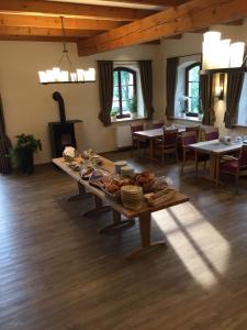 ein großer Tisch in einem Zimmer mit Tischen und Stühlen in der Unterkunft Hotel Zur-Borke in Neuenrade