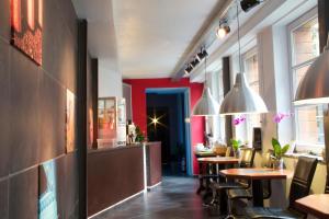 a restaurant with tables and chairs and a bar at BXLROOM Guesthouse in Brussels