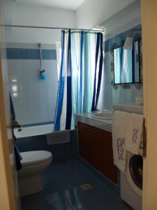 a bathroom with a toilet and a tub and a sink at Villa Emma in Agia Fotia