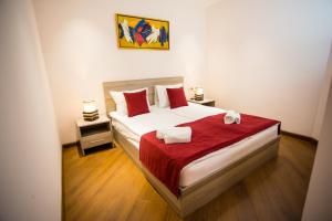 a bedroom with a bed with two towels on it at Welcome Yerevan Apartments in Yerevan