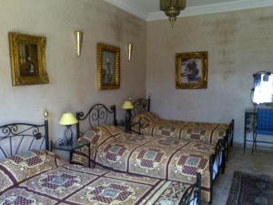Voodi või voodid majutusasutuse Hotel Riad L' Arganier D' Or toas