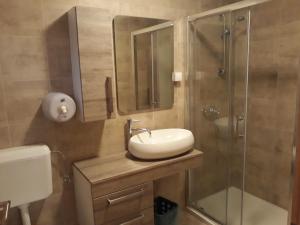 a bathroom with a sink and a shower at San Lorenzo in Lopar +184 photos