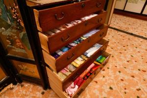 a drawer full of drawers filled with sewing needles at Ryokan Tamura in Kusatsu