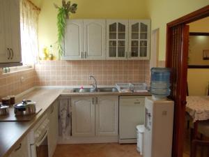 a kitchen with white cabinets and a sink at Apartment Jelaca in Herceg-Novi +145 photos