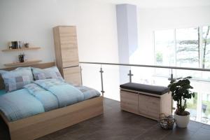 a bedroom with a bed and a large window at Ferienpark Kunterbunt in Krakow am See