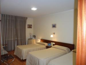 Postel nebo postele na pokoji v ubytování Hostal Coruña