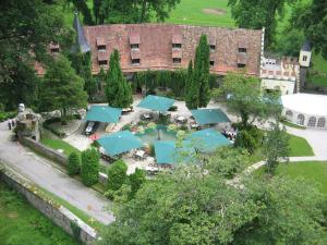 an aerial view of a house with a garden with blue umbrellas at Schloss Egg in Bernried