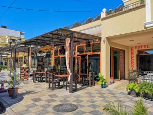 an outdoor patio with tables and chairs outside of a store at Empera H-l in Sunny Beach