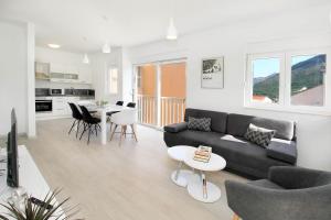 a living room with a couch and a table at Bacan Family Apartments in Cavtat