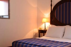 Cama ou camas em um quarto em Pousada Mosteiro de Guimaraes