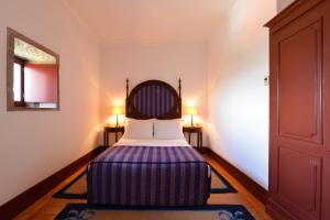 Cama ou camas em um quarto em Pousada Mosteiro de Guimaraes