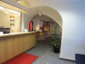 a restaurant with a counter and a potted plant at Hostel Dalagatan in Stockholm