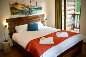 um quarto com uma cama com duas toalhas em The Dragon's Lair Chalet em Demanovska Dolina