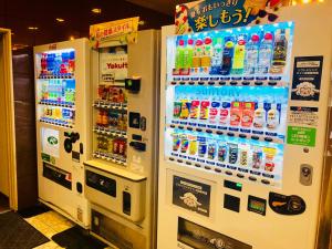 two vending machines with soda and other drinks at Hotel Route-Inn Ageo in Ageo