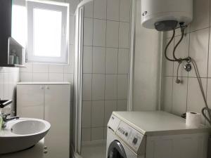 a bathroom with a washing machine and a sink at Apartment Noel in Novalja +22 photos