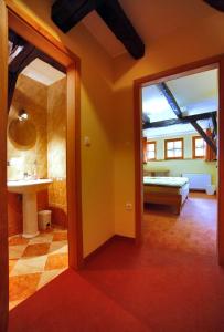 a room with a bathroom with a sink and a mirror at Bed & Breakfast Šilak in Ptuj