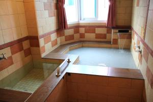a bath room with a tub filled with water at Li Tang in Baihe