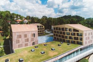 an aerial view of two buildings with a grass roof at Terme Tuhelj Hotel Well in Tuheljske Toplice
