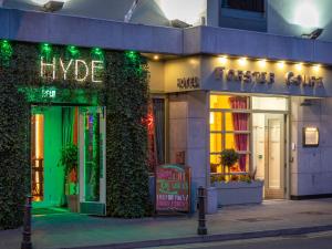 a store front with green lights on a street at HYDE Hotel in Galway