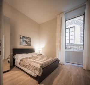 Postel nebo postele na pokoji v ubytování Hotel Torre Guelfa Palazzo Acciaiuoli