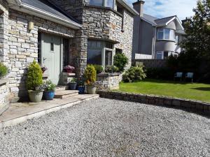 a house with a gravel driveway in front of it at Mill Lane in Buncrana