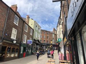 a group of people walking down a street with buildings at Durham 3 Bedroom House With Parking in Durham